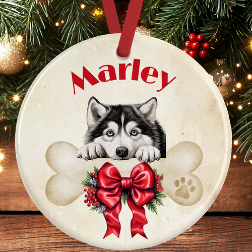 Alaskan Malamute Christmas Tree Decoration - Alaskan Malamute Dog peering over a dog bone decorated with a festive bow. 